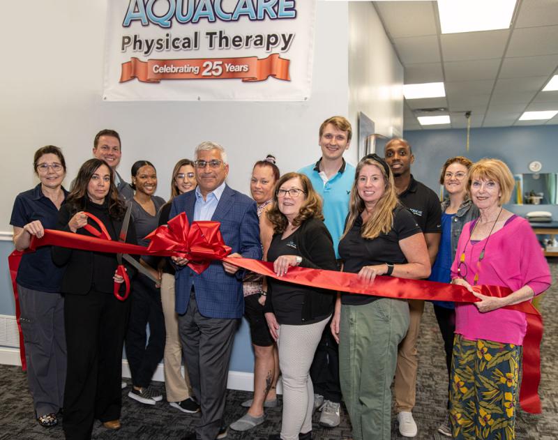 Aquacare Lewes - Route 24 ribbon-cutting attendees shown are (l-r) Bryan Morgan, PTA; Sha'liyah Palmer, Morgan Vance, and Christine Dickinson, exercise specialists; Alec Crichton, PT, DPT; Mark Bogle, PTA; and Rachel Swick Mavity, communications director. In front are Robin Sipp, PT, clinical director; Cara Konlian, MSPT, CEO; Dr. Steve Konlian, CFO; Barbara Fidler, PTA; Sarah Hope, front desk coordinator; and Betsy Reamer, Lewes Chamber of Commerce executive director. SUBMITTED PHOTO